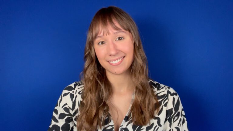 A still from a selftape. The subject, a girl, is wearing a black and white blouse